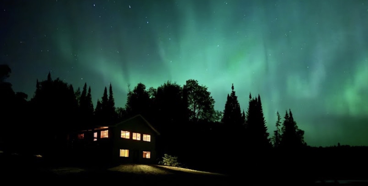 Aurora borealis above a Timber Wolf built home